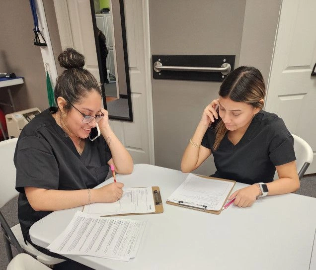 students filling out documents for patients